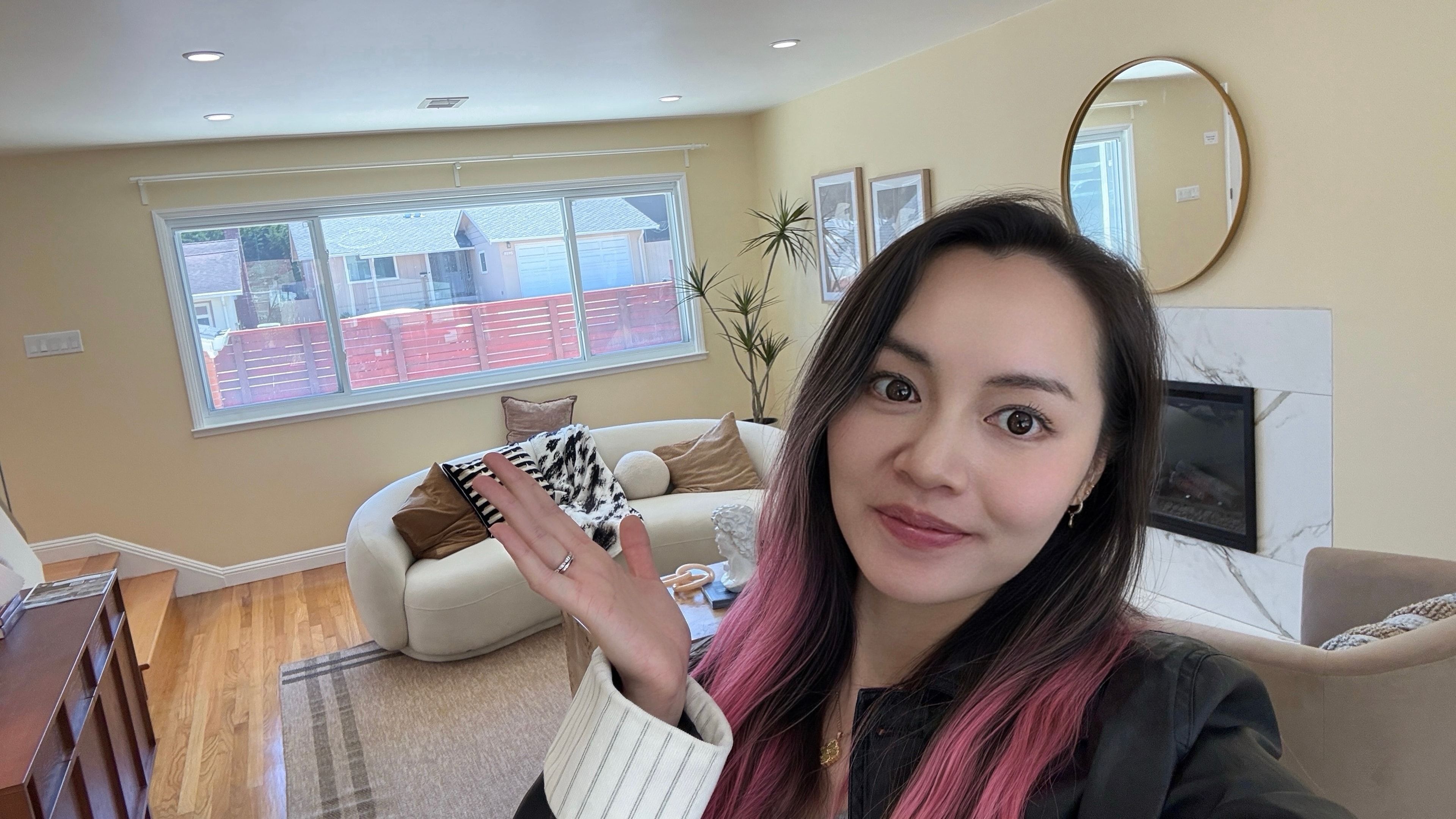 Ziki in a staged living room with a sofa and fireplace